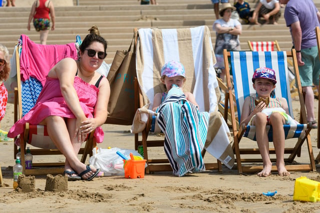 Michelle McCann, Cara McCann and Ellis Mullan enjoying Blackpool beach in deck chairs