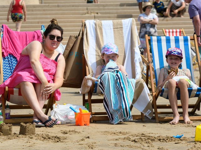 Michelle McCann, Cara McCann and Ellis Mullan enjoying Blackpool beach in deck chairs