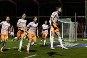 Matthew Pennington celebrates his crucial goal against Northampton.