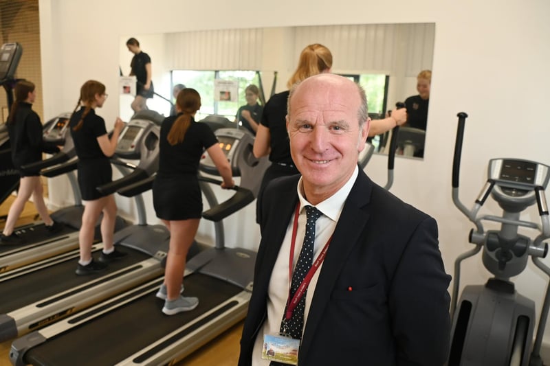 Retiring PE school teacher John Armfield, with pupils enjoying the new facilities at the sports hall