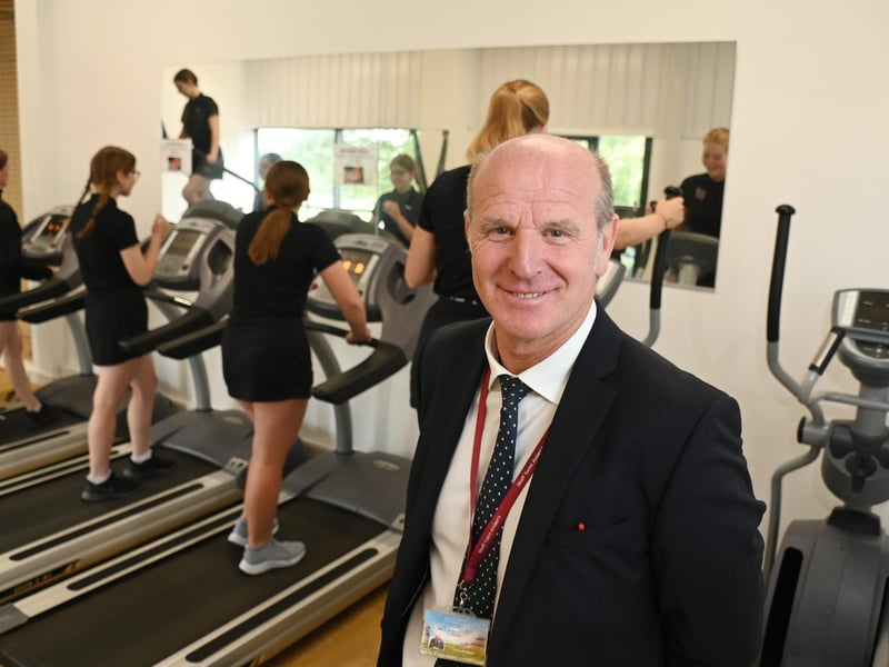 Retiring PE school teacher John Armfield, with pupils enjoying the new facilities at the sports hall