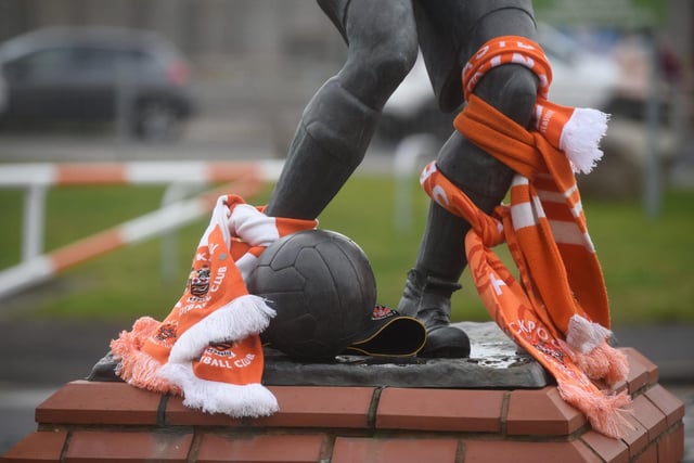 Blackpool FC scarves were placed on the Mortensen Statue outside Bloomfield Road in honour of Mr Johnson.