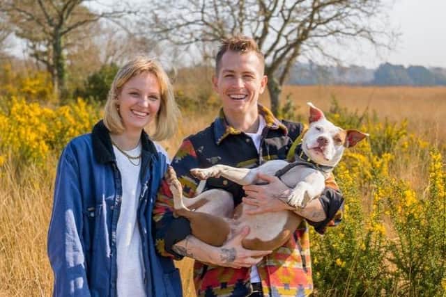 James and Kirstie Brittain-McVey holding their dog Moochie