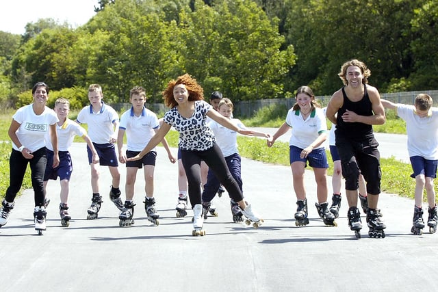 Skating lessons at Palatine High School. Female World Inline skating champion Jenna Downing (left), Britains Got Talent star Marawa (centre) and Leo Oppenheim of Flowskate with students from the school