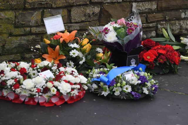 Some of the floral tributes in memory of the officers who perished.