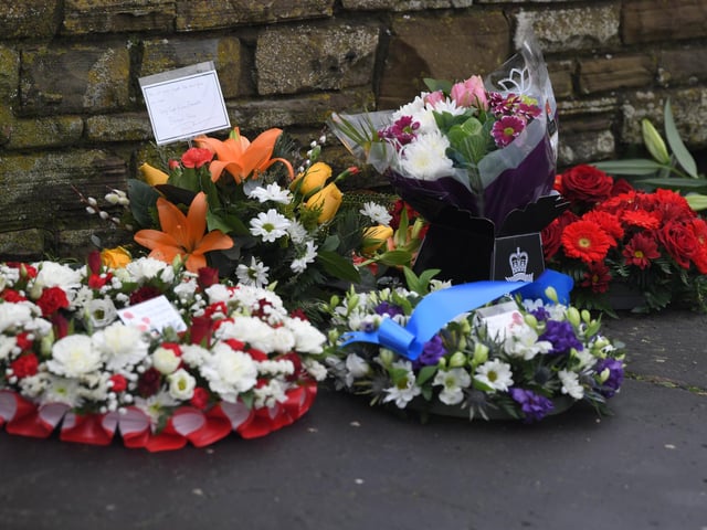 Some of the floral tributes in memory of the officers who perished.