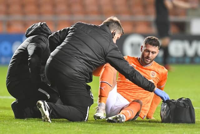 Gary Madine receiving treatment from the medical staff during the defeat to Hull