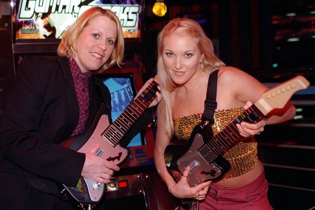 Attack of the Mad Axe Girls!! Zoe Clifford Assistant Manager of The Palace Nightclub and  Dancer Anna Leigh try out the latest video game in 1999