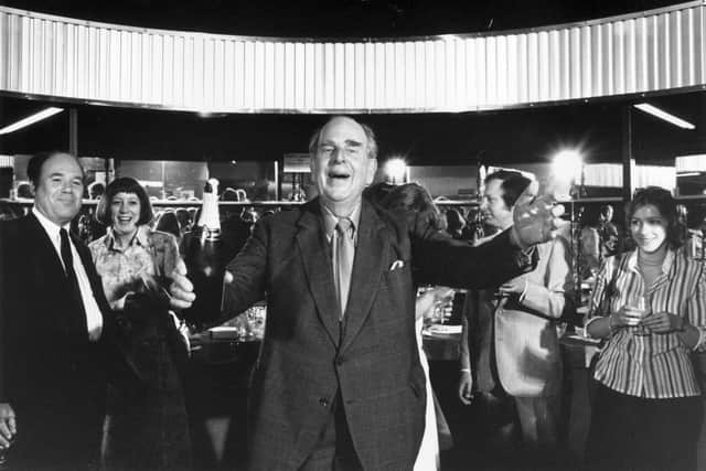 Robert Morley holding a bottle of champagne at a reception to launch his book 'A Musing Morley' at the Lyric Theatre, London