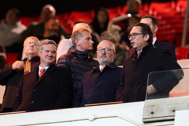 Owner Simon Sadler watches on alongside chief executive Ben Mansford, left, and director Brett Gerrity, centre