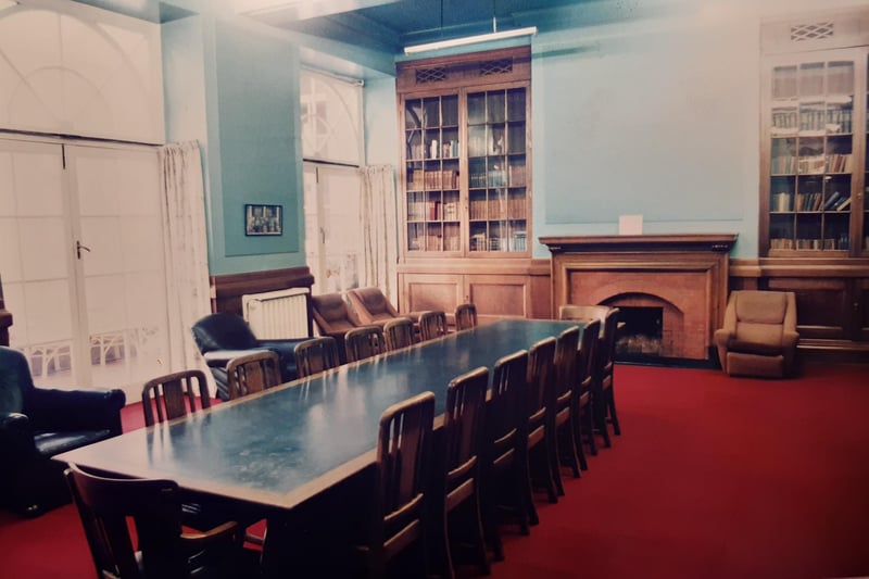 The library, with its long table, comfortable seating and fireplace. The doors opened out on to the balcony