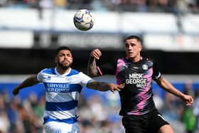LONDON, ENGLAND - MARCH 20: Andre Gray of Queens Park Rangers is challenged by Oliver Norburn of Peterborough United during the Sky Bet Championship match between Queens Park Rangers and Peterborough United at The Kiyan Prince Foundation Stadium on March 20, 2022 in London, England. (Photo by Alex Davidson/Getty Images)