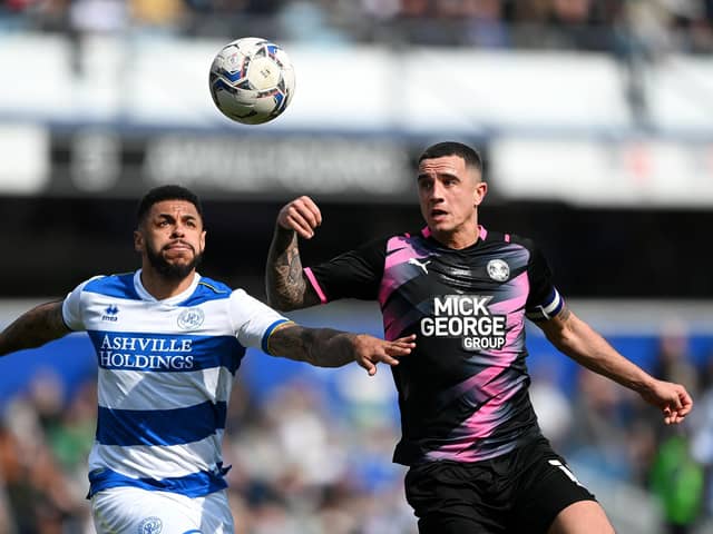 LONDON, ENGLAND - MARCH 20: Andre Gray of Queens Park Rangers is challenged by Oliver Norburn of Peterborough United during the Sky Bet Championship match between Queens Park Rangers and Peterborough United at The Kiyan Prince Foundation Stadium on March 20, 2022 in London, England. (Photo by Alex Davidson/Getty Images)