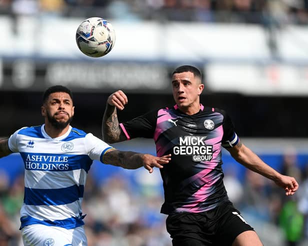 LONDON, ENGLAND - MARCH 20: Andre Gray of Queens Park Rangers is challenged by Oliver Norburn of Peterborough United during the Sky Bet Championship match between Queens Park Rangers and Peterborough United at The Kiyan Prince Foundation Stadium on March 20, 2022 in London, England. (Photo by Alex Davidson/Getty Images)