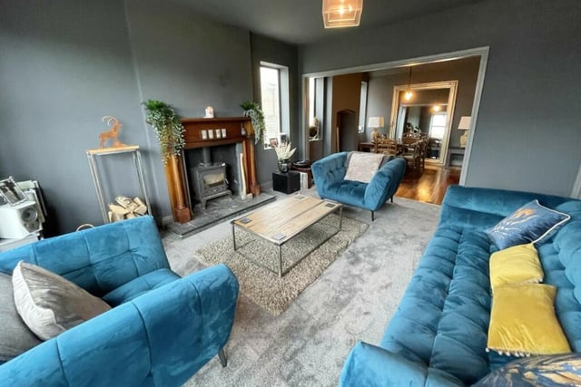 The stunning lounge with a log burner is open plan to the dining area. It has smoked acoustic glass windows to the front