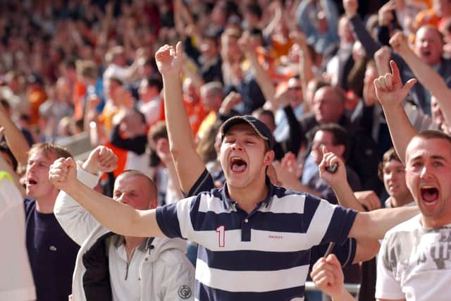 Supporters celebrate Blackpool's crucial victory at the full-time whistle