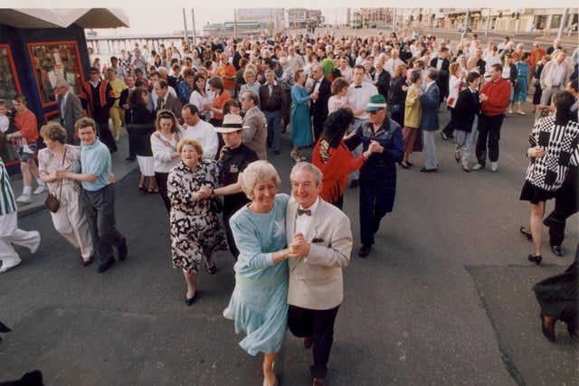 Pat and Ken Rayner(front) lead 200 Dancers Quickstepping along the Golden Mile for Charity in 1992