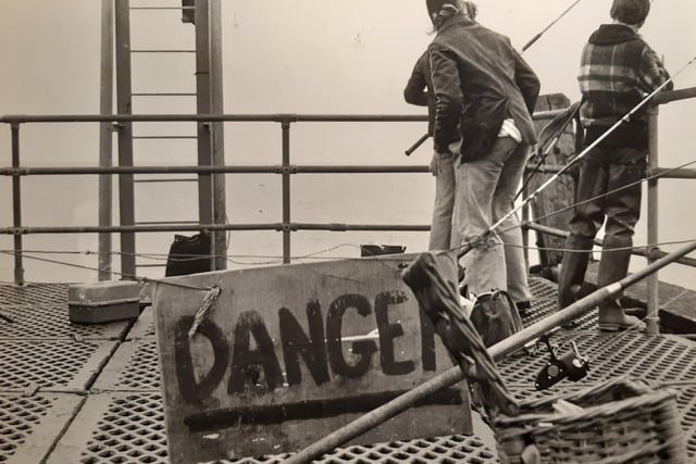 A danger sign heeds a warning to fishermen. It needed repairing but the caption on the back of the photos says the 40ft section of the pier jetty was not going to be demolished