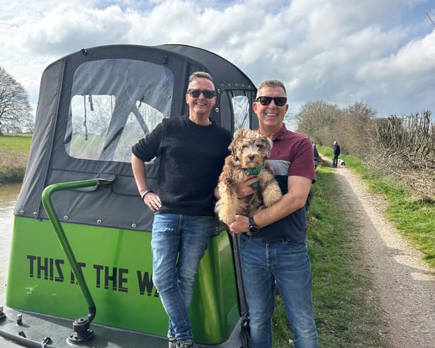Paul (right) with his partner Anthony (left) and their puppy Sebastian.