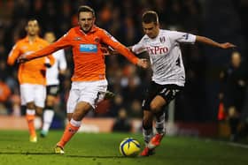 LONDON, ENGLAND - JANUARY 05:  Neal Eardley (L) of Blackpool and Alexander Kacaniklic (R) of Fulham challenge for the ball during the FA Cup with Budweiser Third Round match between Fulham and Blackpool at Craven Cottage on January 5, 2013 in London, England.  (Photo by Ian Walton/Getty Images)