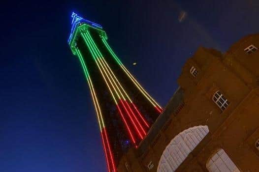 Blackpool Tower lit up in the colours of red, green, gold and blue of National Windrush Day