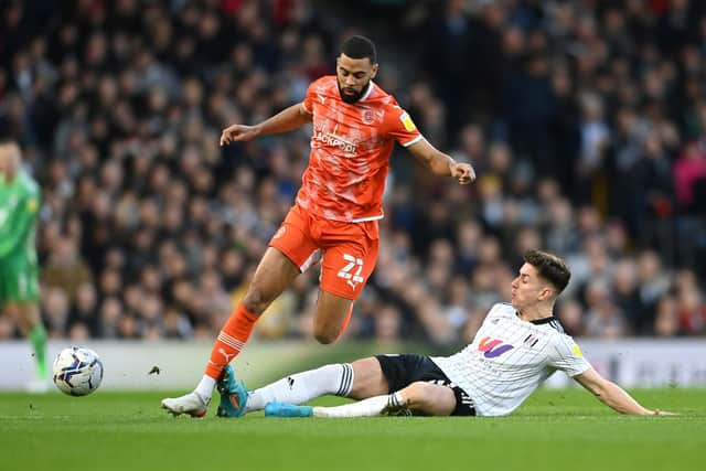 LONDON, ENGLAND - JANUARY 29: Tom Cairney of Fulham tackles Marvin Ekpiteta of Blackpool during the Sky Bet Championship match between Fulham and Blackpool at Craven Cottage on January 29, 2022 in London, England. (Photo by Alex Davidson/Getty Images)