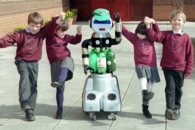 Cycler the recycling robot learns to walk with some of the children at Marton Primary School, Blackpool. Pictured are Matthew Rowley, Abergale Britton, Olivia Freitas-Jones and Ryan Calvert