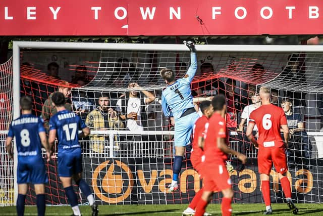 Goalkeeper Chris Neal tips the ball over his bar at Brackley, where a fatigued Fylde side held out for a draw  Picture: STEVE MCLELLAN