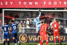 Goalkeeper Chris Neal tips the ball over his bar at Brackley, where a fatigued Fylde side held out for a draw  Picture: STEVE MCLELLAN