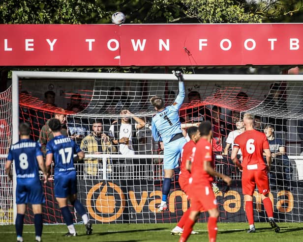 Goalkeeper Chris Neal tips the ball over his bar at Brackley, where a fatigued Fylde side held out for a draw  Picture: STEVE MCLELLAN