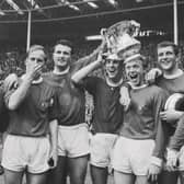 Manchester United players after winning the 1963 FA Cup Final against Leicester City at Wembley Stadium in London, UK, 25th May 1963. United won 3-1. 
From left to right, Tony Dunne, Bobby Charlton, team captain Noel Cantwell, Pat Crerand, Albert Quixall, David Herd and Johnny Giles (far right). (Photo by Evening Standard/Hulton Archive/Getty Images)
