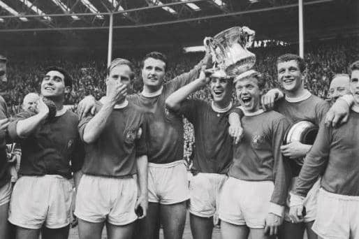 Manchester United players after winning the 1963 FA Cup Final against Leicester City at Wembley Stadium in London, UK, 25th May 1963. United won 3-1. 
From left to right, Tony Dunne, Bobby Charlton, team captain Noel Cantwell, Pat Crerand, Albert Quixall, David Herd and Johnny Giles (far right). (Photo by Evening Standard/Hulton Archive/Getty Images)
