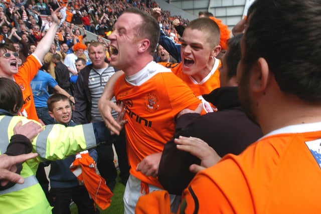 Adam celebrates with supporters after Blackpool secured their play-off spot with a draw against Bristol City