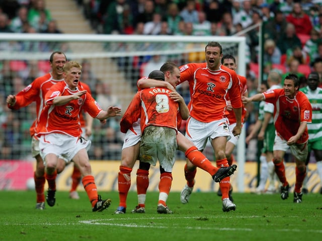 The Blackpool squad celebrate.