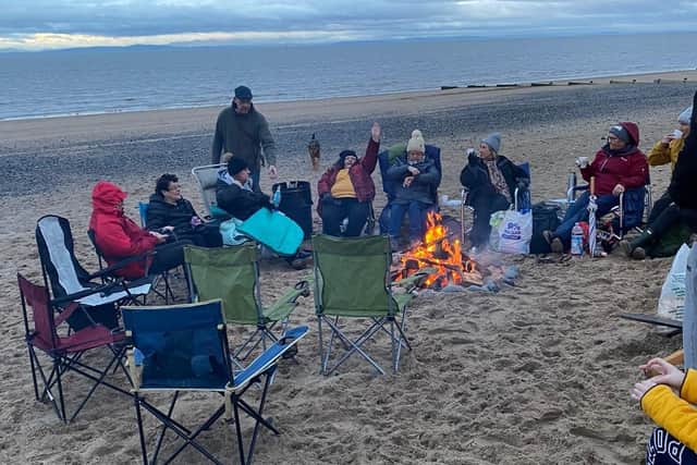 A fire kept the chills at bay for Jane Couch and members of the aptly-named women's group the Chill Lounge during their overnight beach event on Friday October 31.