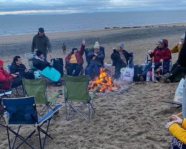 A fire kept the chills at bay for Jane Couch and members of the aptly-named women's group the Chill Lounge during their overnight beach event on Friday October 31.