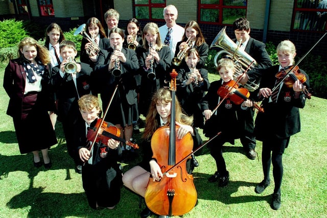 A group of music pupils hit a high note with their recent exams, when they all achieved a 100% pass rate in 1998. Pic shows the pupils with Head of Music Rachael Thomas, Head Alan Harvey and Pianist and Deputy Head Phil Taylor