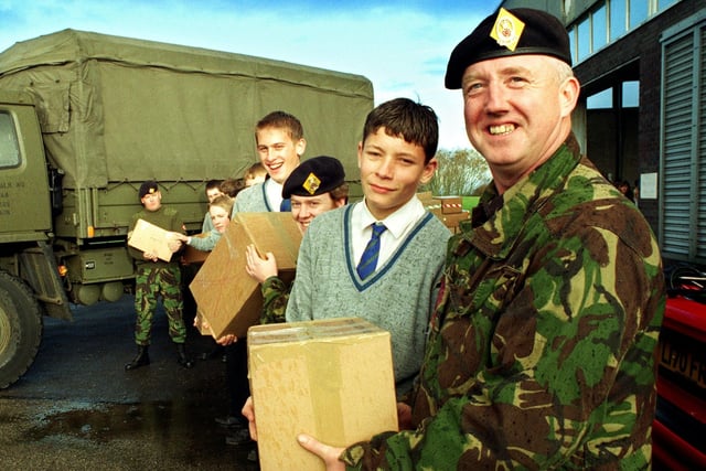 Colour Sgt John Davies (4th Battalion Queens Lancashire Regiment) and 14-year-old Anthony Watkins (St. Mary's RC High School) loading up Christmas presents collected and packed at the National Savings Centre, Marton.  The school and the battalion joined forces to load up the trucks.-