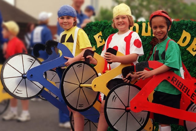 Ready to speed off in the Garstang Children's Festival procession are Leanne Murray, Sara Sefton and Khalid Baraka, aged seven, part of Garstang CP School's "Tour De France" tableaux