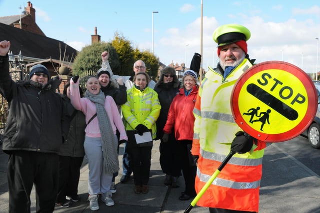 Lollipop man John Neil is pictured with parents and staff on Devonshire Road in 1998