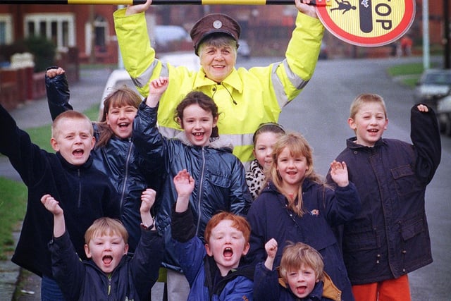 Lollipop lady Margaret Brown MBE with a gang of youngsters in Layton, 1999