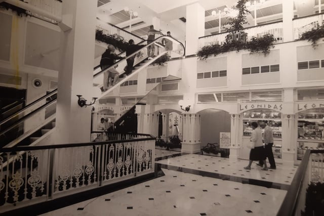 Can you remember this? The caption on the back says 'The spacious shopping centre entrance area, there are marble floors throughout' There's definitely a familiarity about it and you can see where Littlewoods sprang from - and Primark