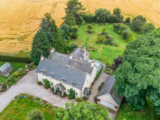 Aerial view of property and grounds.