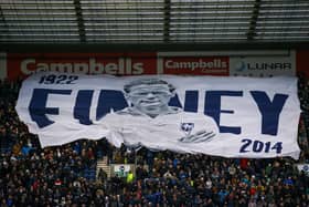 Preston North End fans with a Tom Finney surfer flag during their derby win over Blackpool.
