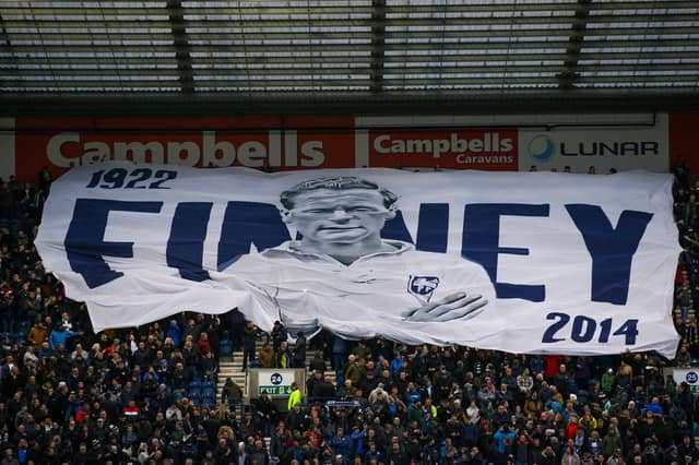 Preston North End fans with a Tom Finney surfer flag during their derby win over Blackpool.