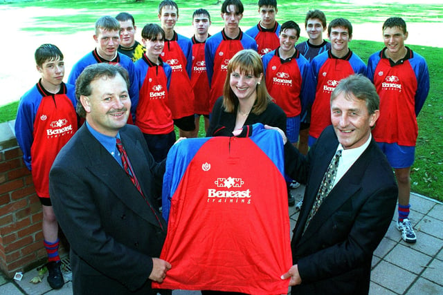 Mike Ruman (right) general manager of Beneast Training, hands over a new football team kit to Geoff Jenkins who was the Y11 soccer team coach, watched by the team. Also pictured is Beneast Marketing Manager - Vicky Wright.