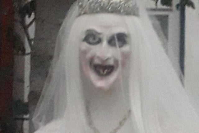 Despite the lovely gown and veil, this bride till looks creepy!