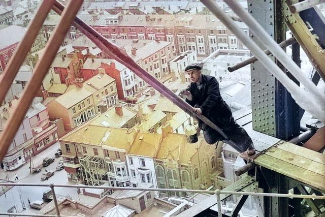 Painting the tower. The colour of the tower's deep red has been picked up by the colour app, as has the man balancing precariously...