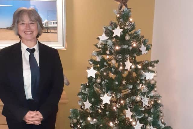 Funeral Arranger Carole Pickering with the branch memorial tree. Photo: e : J&A Porter Funeral Directors