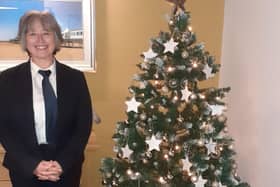 Funeral Arranger Carole Pickering with the branch memorial tree. Photo: e : J&A Porter Funeral Directors
